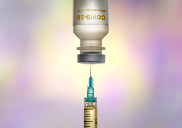 covid 19 vaccine and syringe on