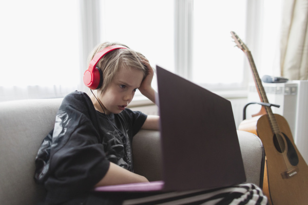 boy with headphones and laptop on