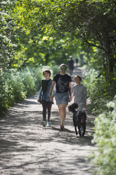 mother and sons with dog walking