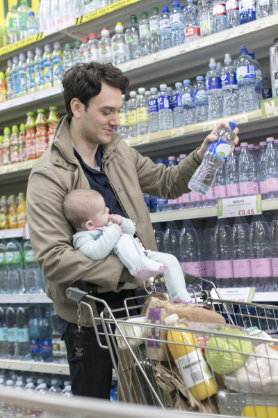 father with baby daughter grocery shopping