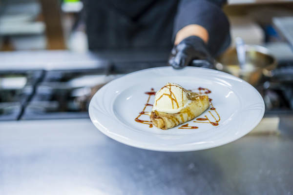 chef showing plate with crepe and