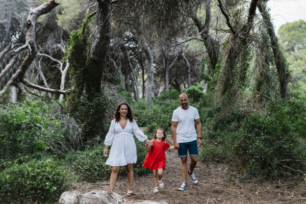 family walking on trail in forest