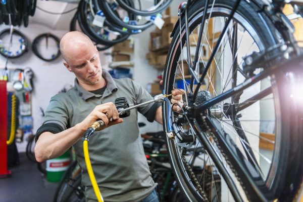 bicycle mechanic working in bike shop