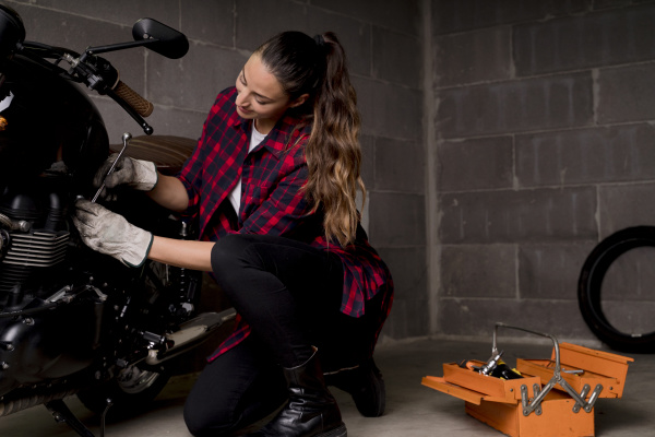 woman repairing motorbike