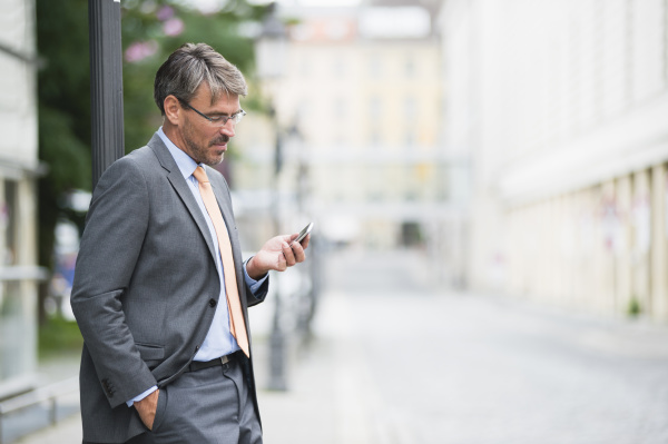 businessman wearing suit using smart phone