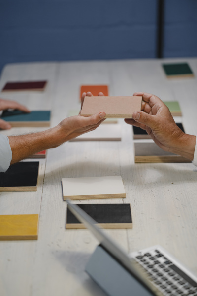 hands of architects choosing colour samples