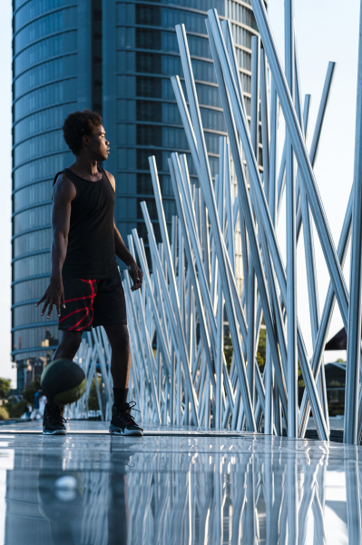 young man playing basketball in modern