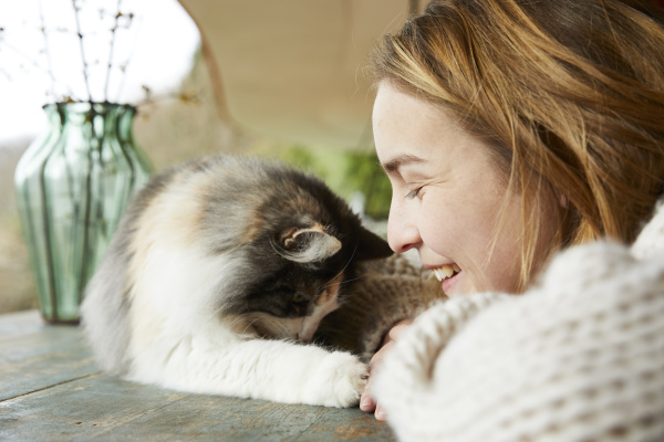 happy woman with norwegian forest cat
