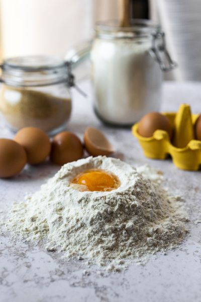 close upof egg yolk in flour