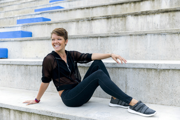 athletic woman sitting on stairs