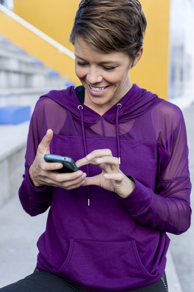 athletic woman using smartphone