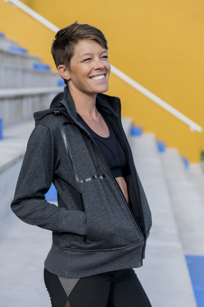 smiling athletic woman on stairs