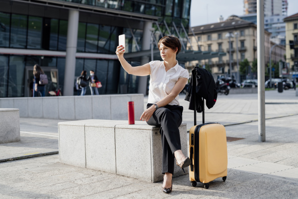 businesswoman taking selfie with smart phone