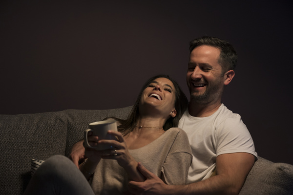 happy loving couple relaxing on sofa