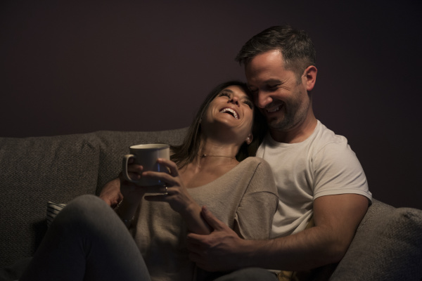 loving couple laughing while relaxing on