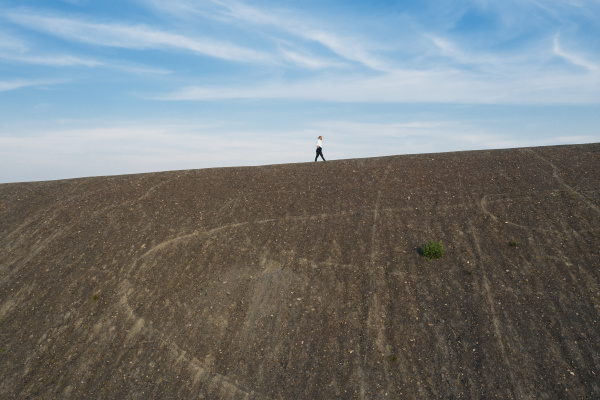 male professional walking on hill during
