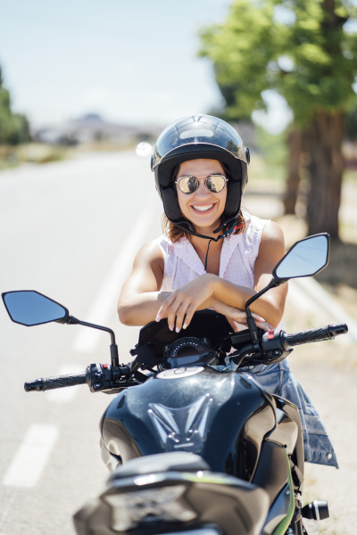 female biker with sunglasses sitting on