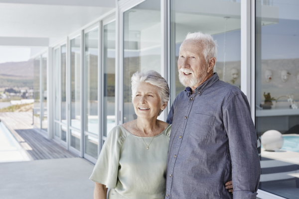 happy senior couple standing at luxury