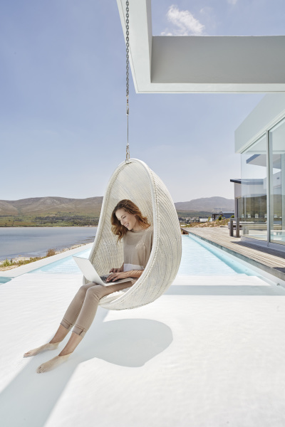 woman sitting in hanging chair above