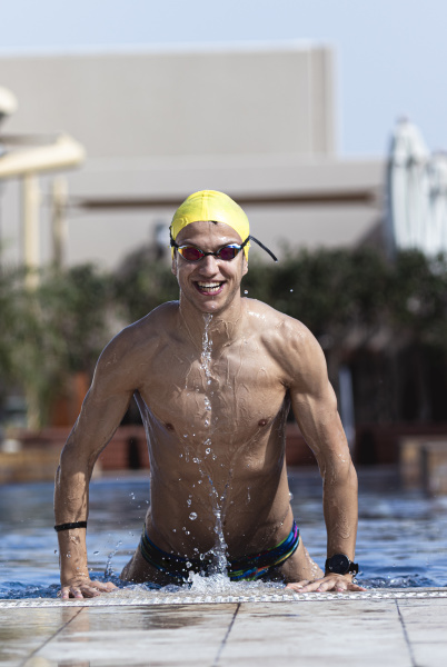 happy swimmer coming out from pool