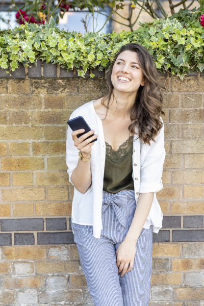 smiling woman portrait holding her smartphone