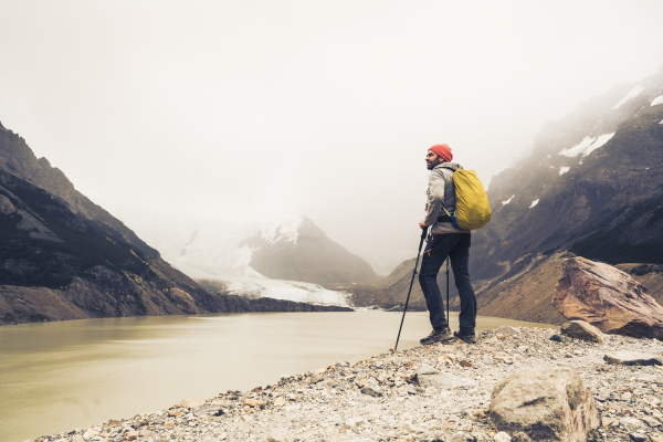 man with hiking poles standing by