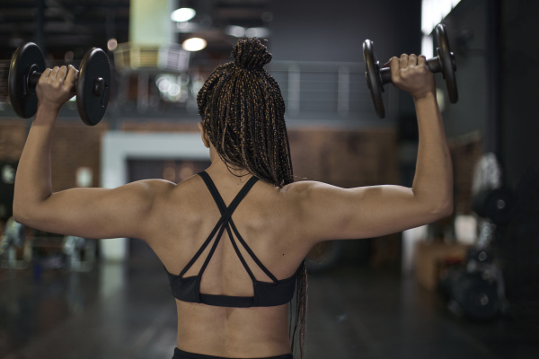female athlete with braided hair lifting