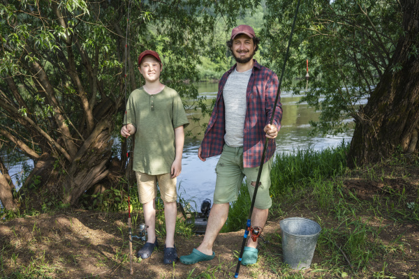 father and son holding fishing rods