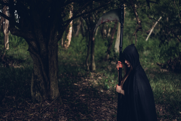 woman horror ghost holding reaper in
