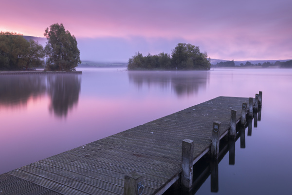pink sunrise over llangorse lake in