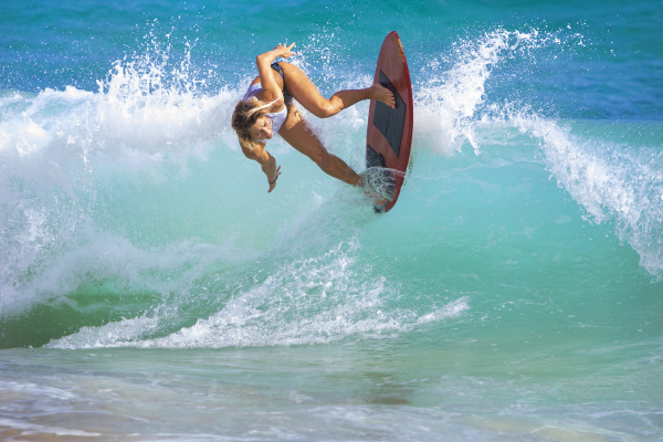 a young woman riding a wave