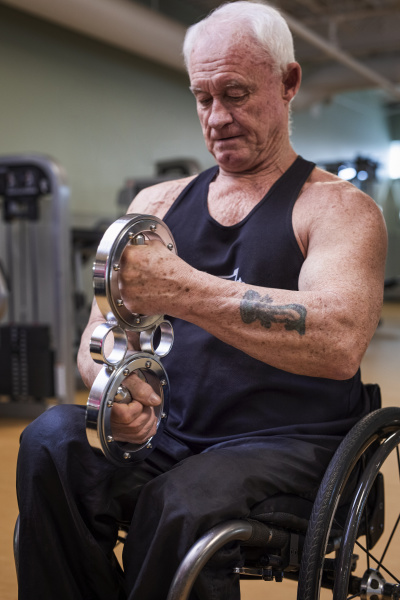 a senior paraplegic man working out