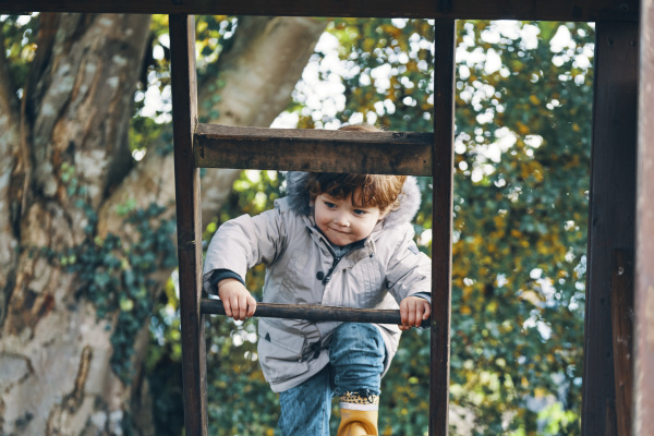a child climbing a ladder with