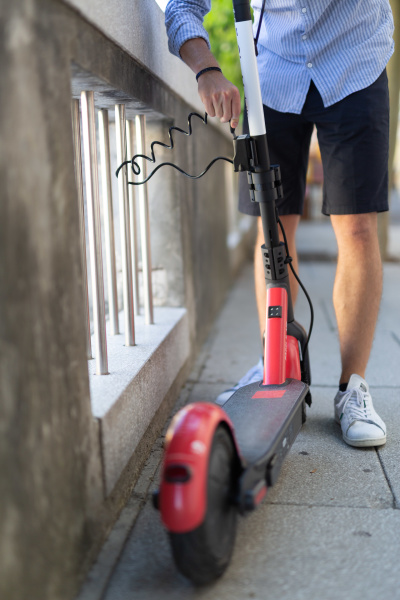 male user safely parking electric scooter