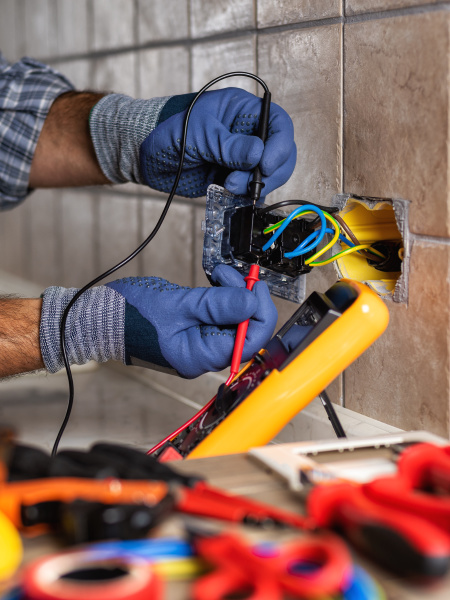 electrician at work with safety equipment