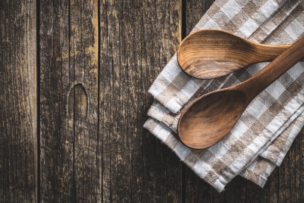 two wooden spoons on checkered napkin