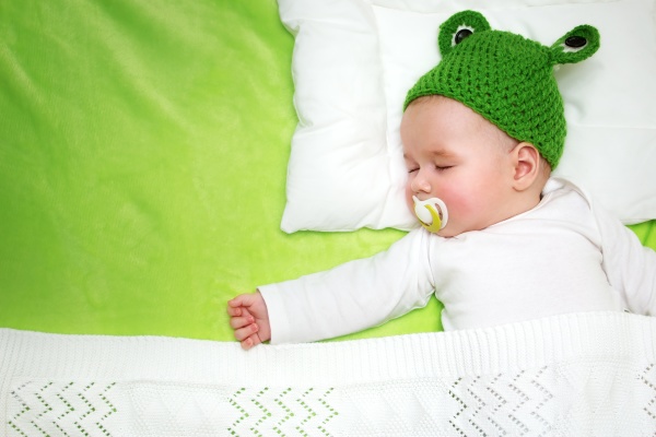baby on green blanket