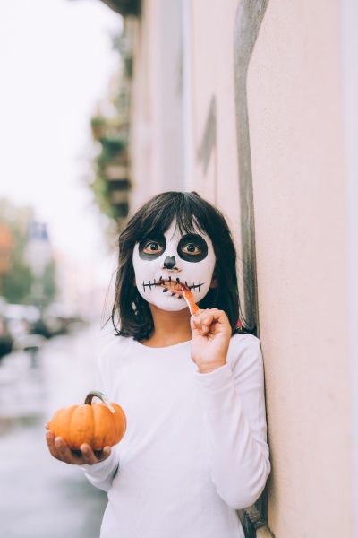 girl with face paint eating