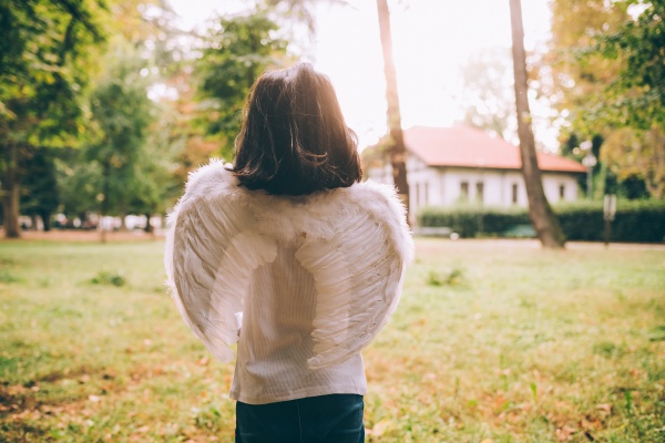 girl wearing angel wings halloween