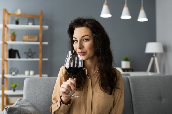 woman drinking red wine in video