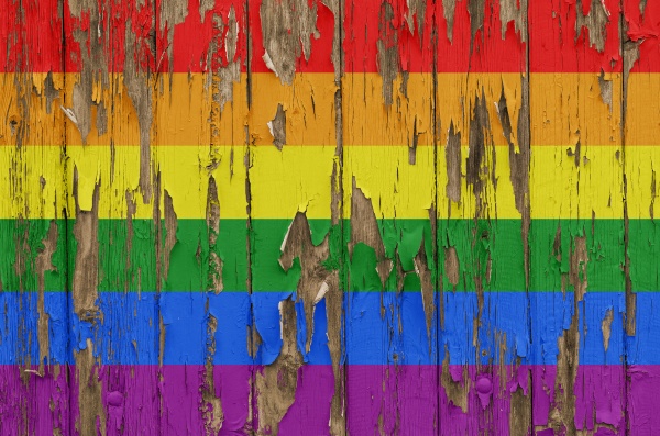 rainbow flag on a weathered wooden