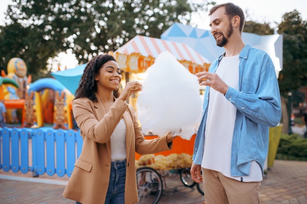 love couple eating cotton candy in