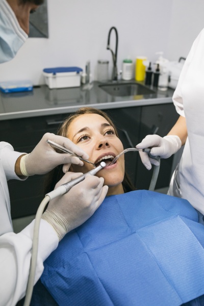 male dentist doing dental treatment of