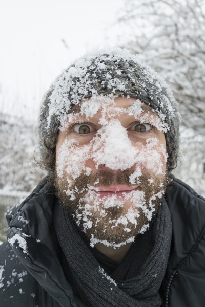 portrait of man with snow in