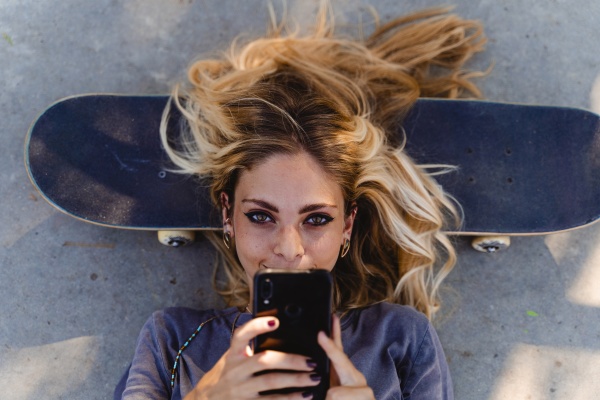 blond woman using smart phone while