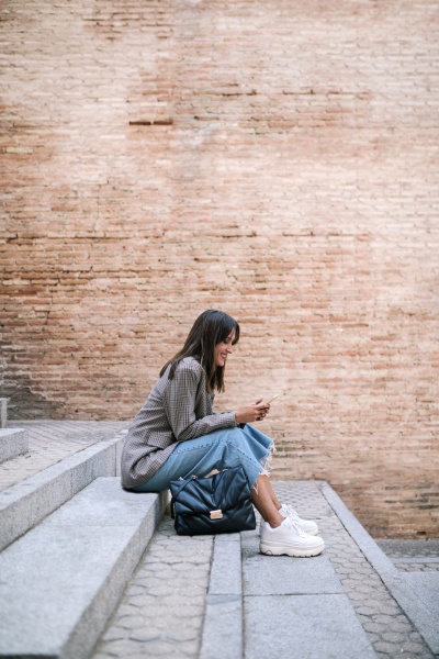 young woman using smart phone while