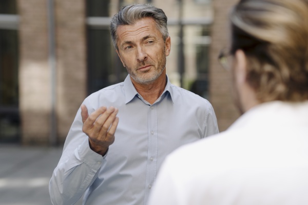 businessman discussing with colleague while standing