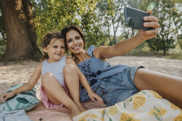 mother and daughter taking selfie on