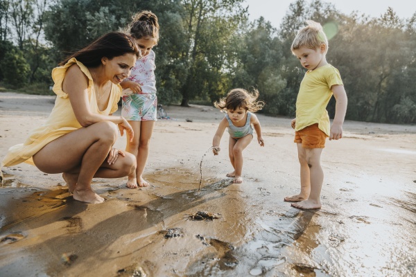 mature woman and children discovering crab
