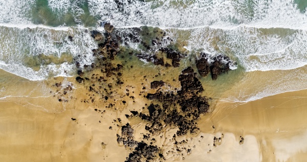 aerial view of rocks on sandy